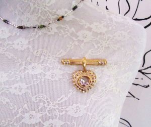 Vintage NOLAN MILLER 1980's gold tone bar brooch or pendant with floating rhinestones heart  - Fashionconservatory.com