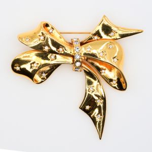 Vintage Joan Rivers Starry Rhinestone Gold Toned Bow Brooch 1990s