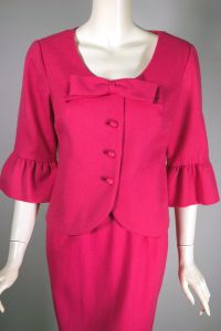 Barbie pink acrylic 1960s skirt suit with bow and ruffle trim  - Fashionconservatory.com