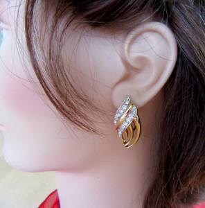 Trifari gold metal & clear rhinestone swirl clip on earrings - Mid Century revival